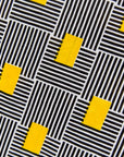 Display of black and white striped dress with yellow block print.