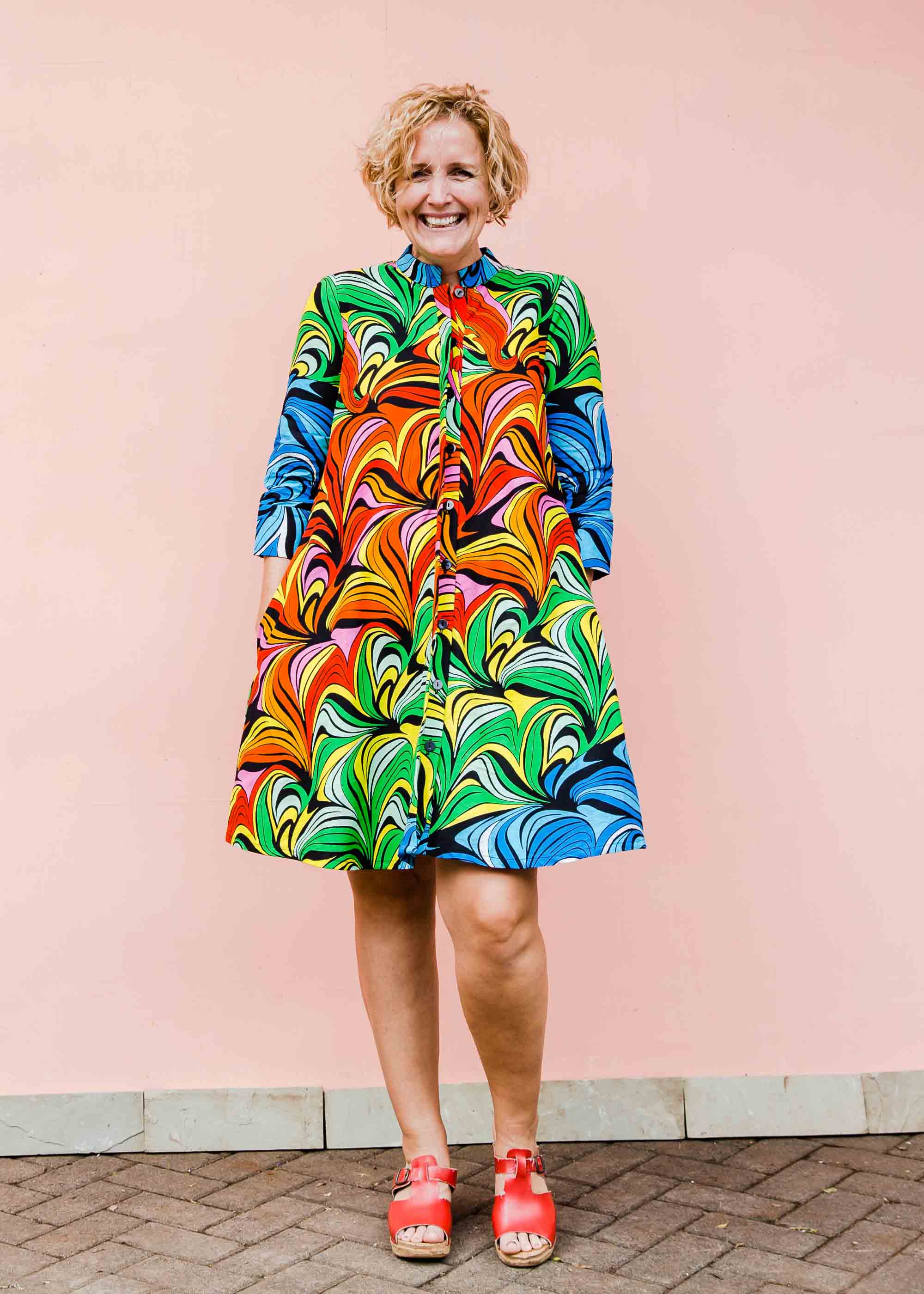 model wearing a rainbow swirl design dress