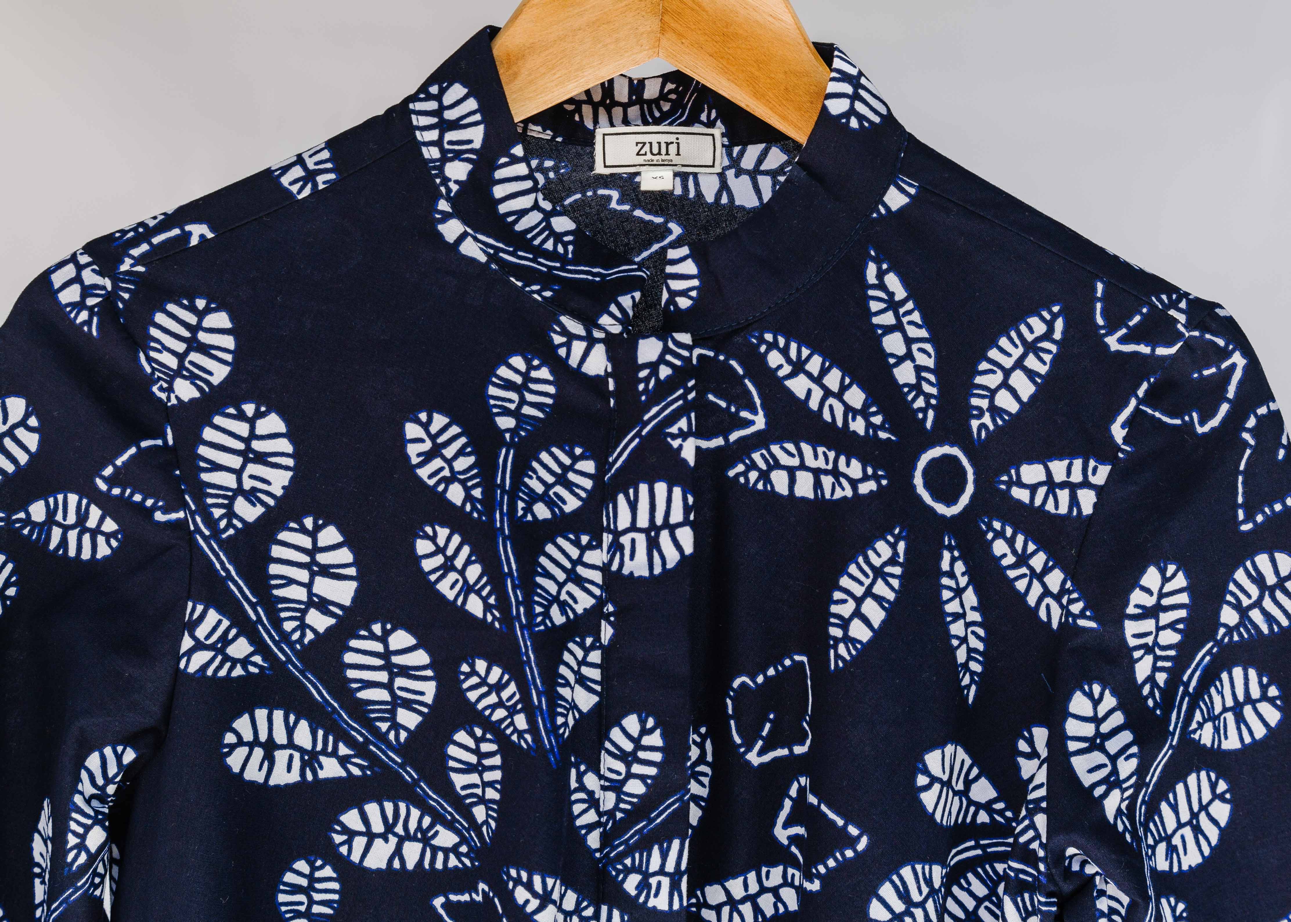 Display of navy dress with white floral print.