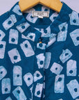 Close up display of blue, white domino print shirt.