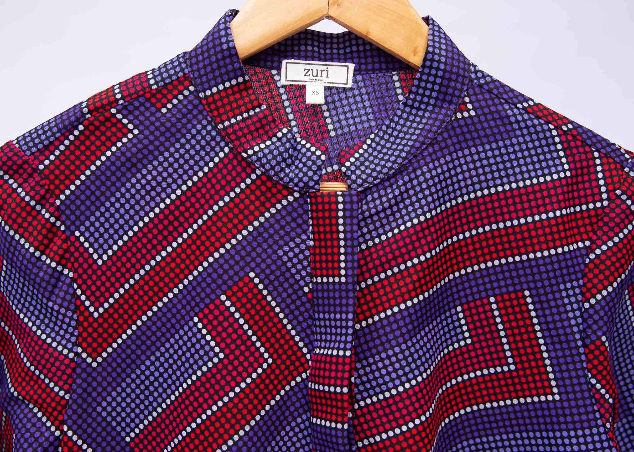 detail of a blue, red and lavender geometric shirt dress