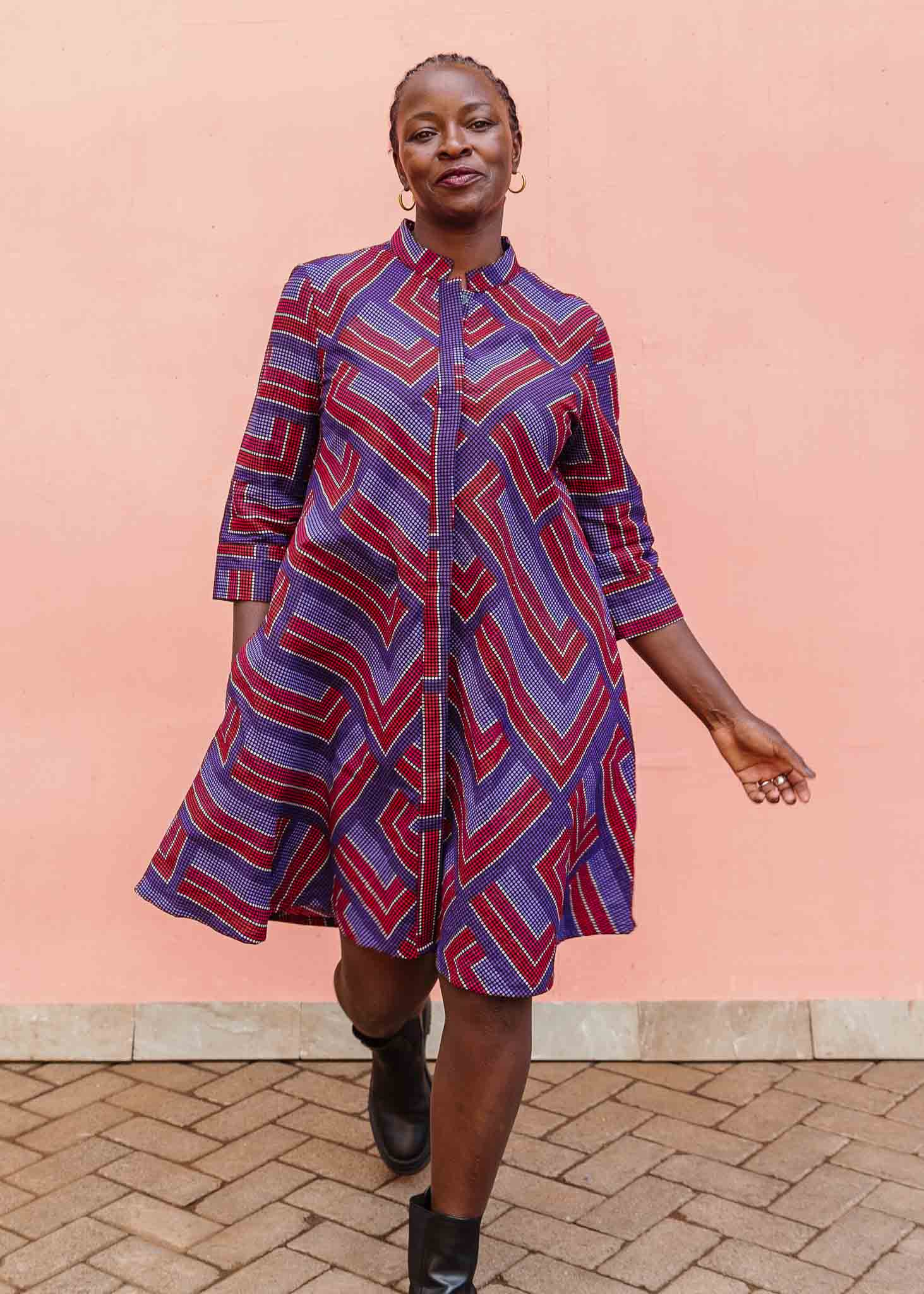 model wearing a blue, red and lavender geometric shirt dress