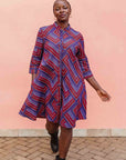 model wearing a blue, red and lavender geometric shirt dress