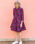 model wearing a blue, red and lavender geometric shirt dress