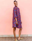 model wearing a blue, red and lavender geometric shirt dress