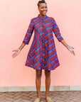 model wearing a blue, red and lavender geometric shirt dress