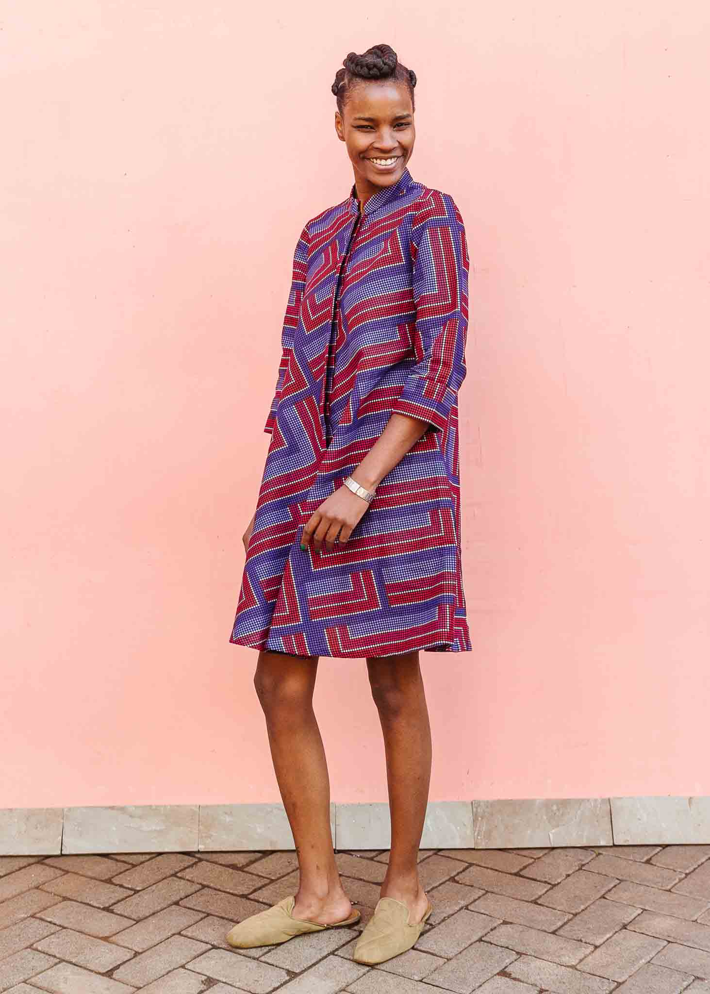 model wearing a blue, red and lavender geometric shirt dress