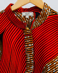 Display of red and brown abstract print dress.