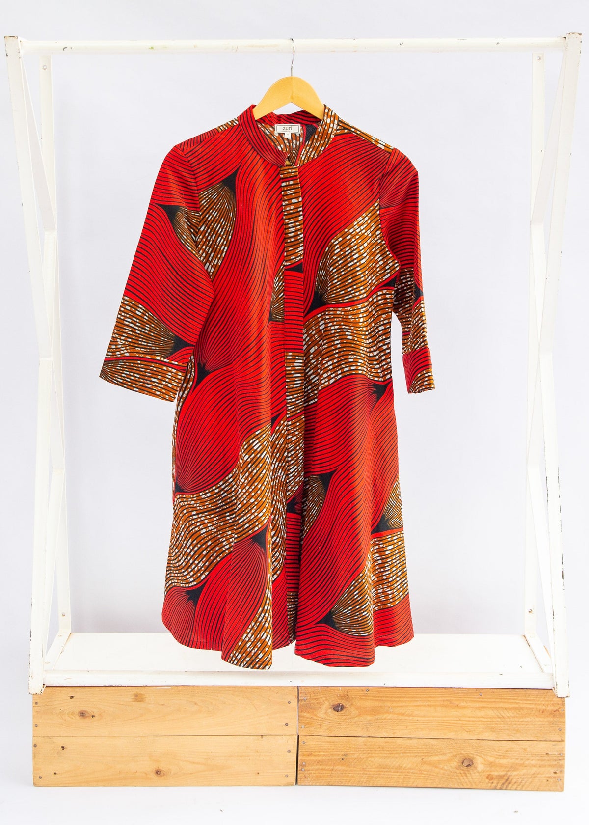 Display of red and brown abstract print dress.