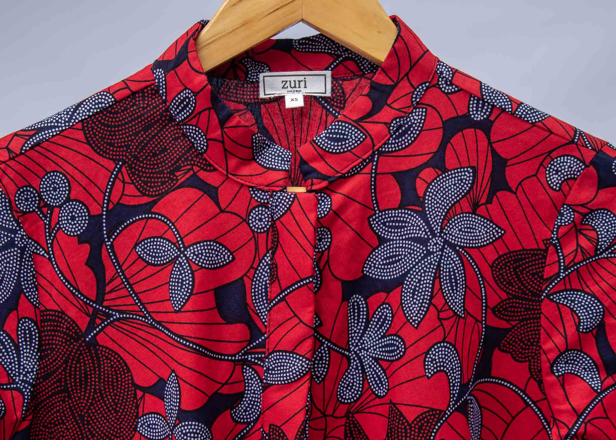 display of red dress with floral vine print.