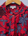 display of red dress with floral vine print.