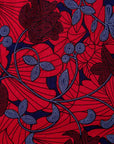 display of red dress with floral vine print.