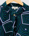 Navy background with blue, green and white dress