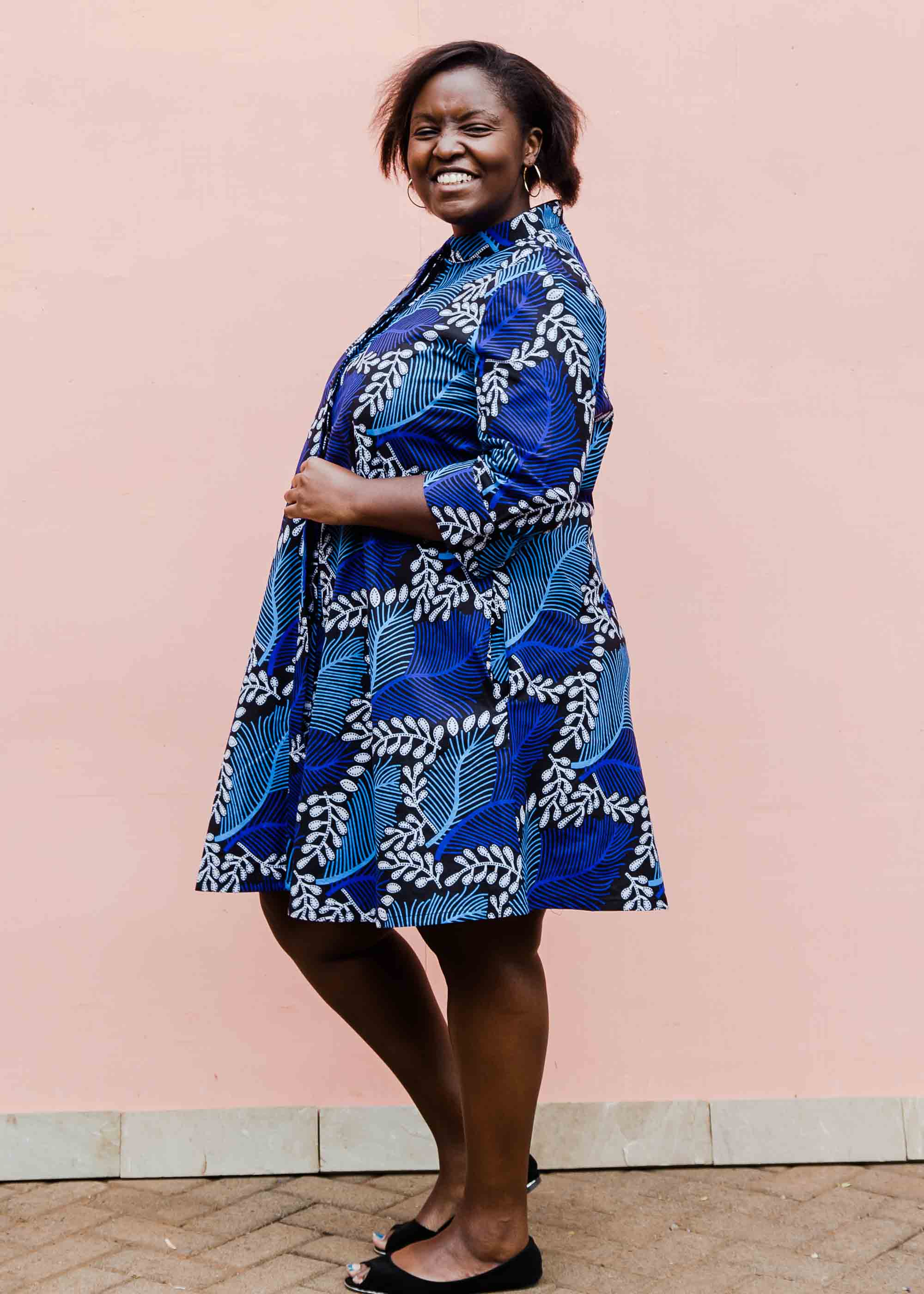 Model wearing blue floral print dress