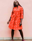 model wearing a red ikat dress