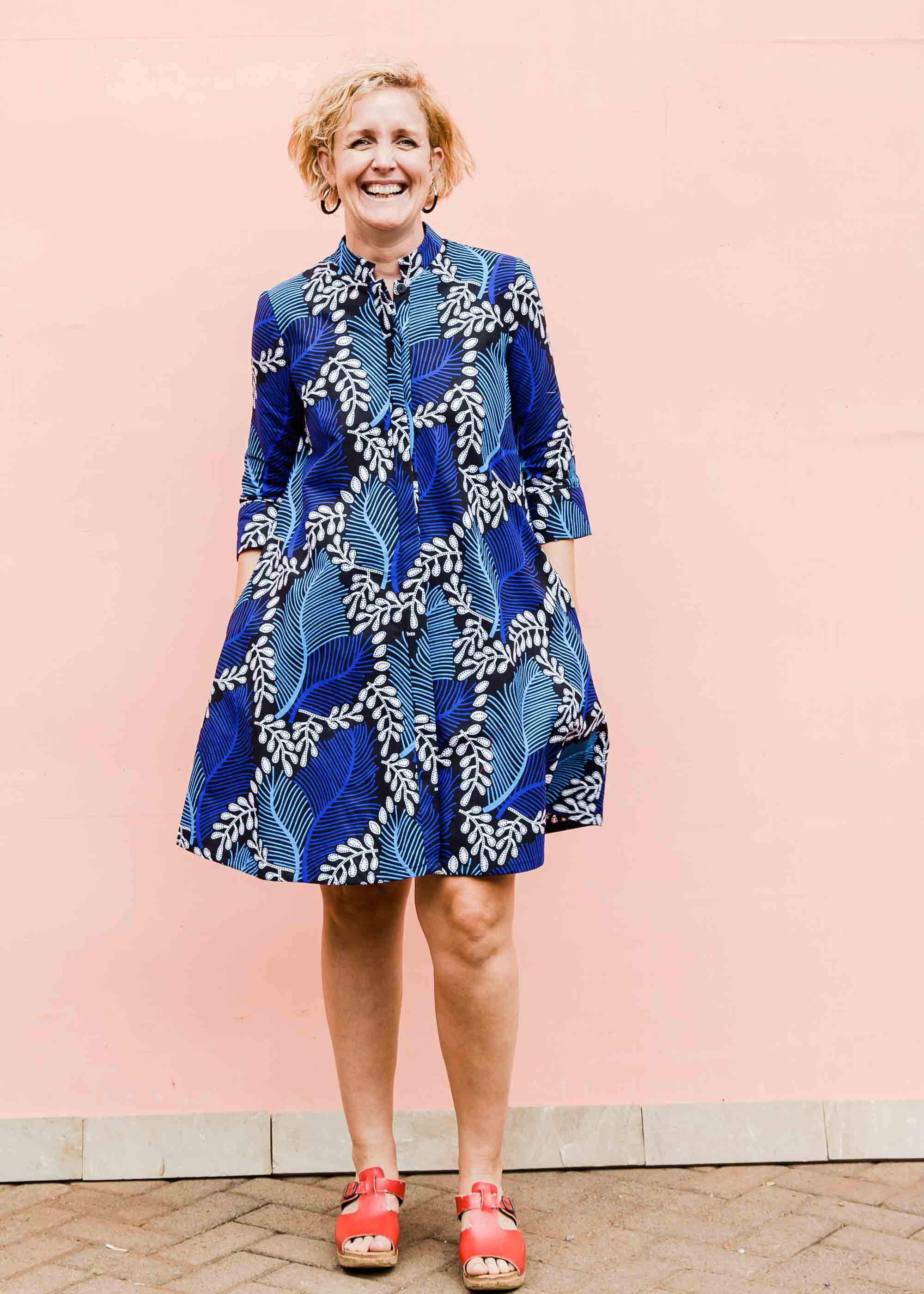 Model wearing blue floral print dress