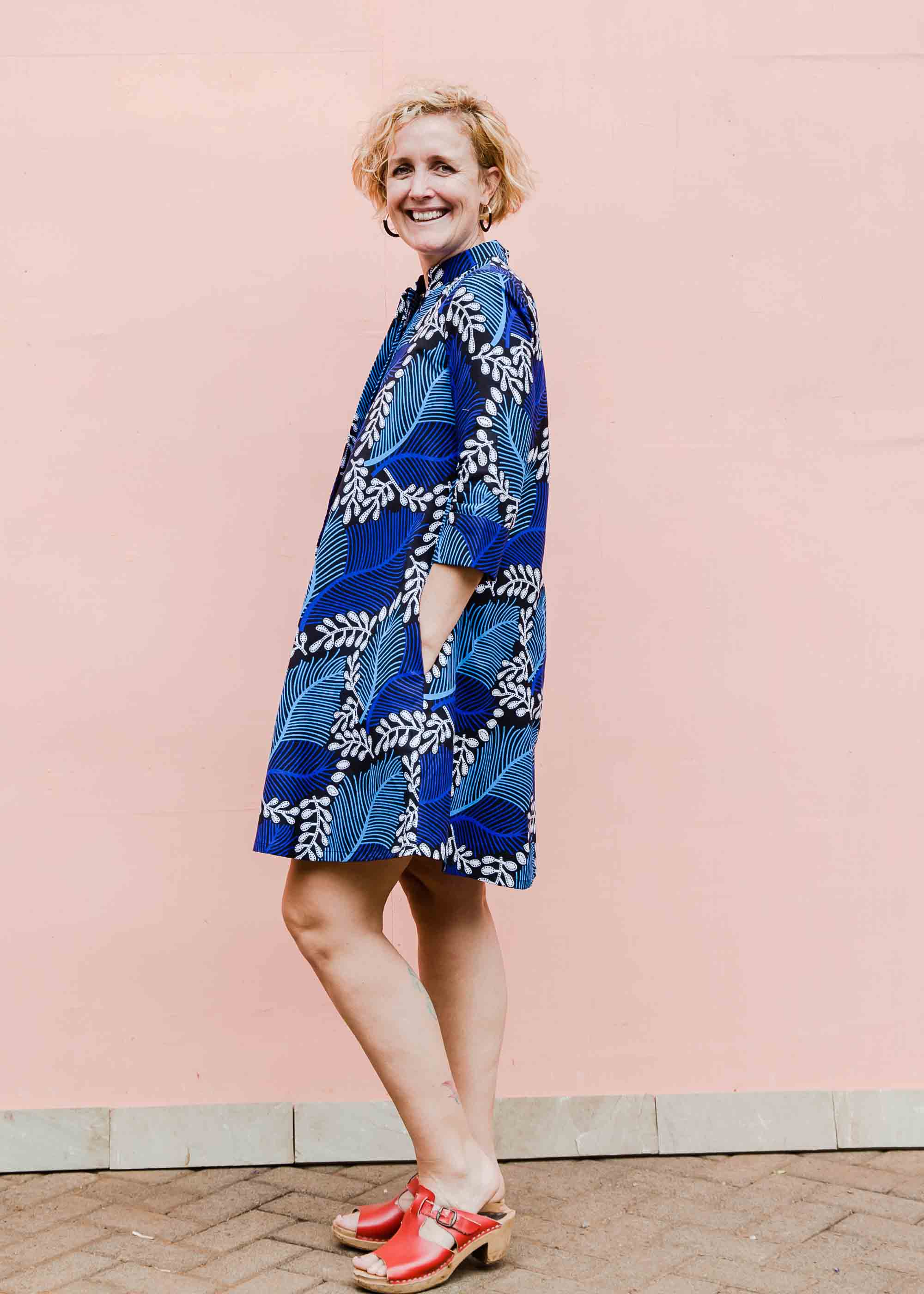 Model wearing blue floral print dress