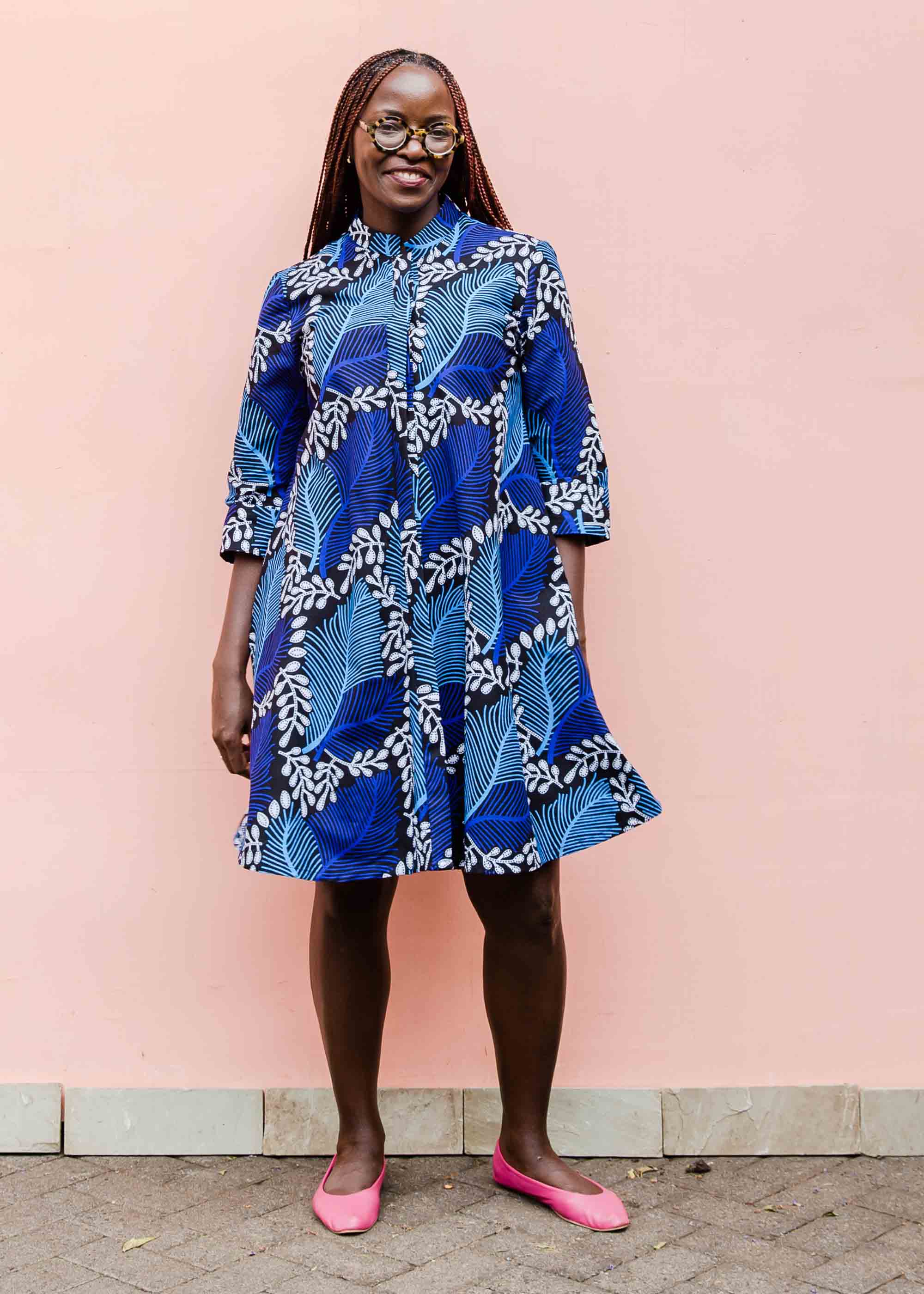 Model wearing blue floral print dress