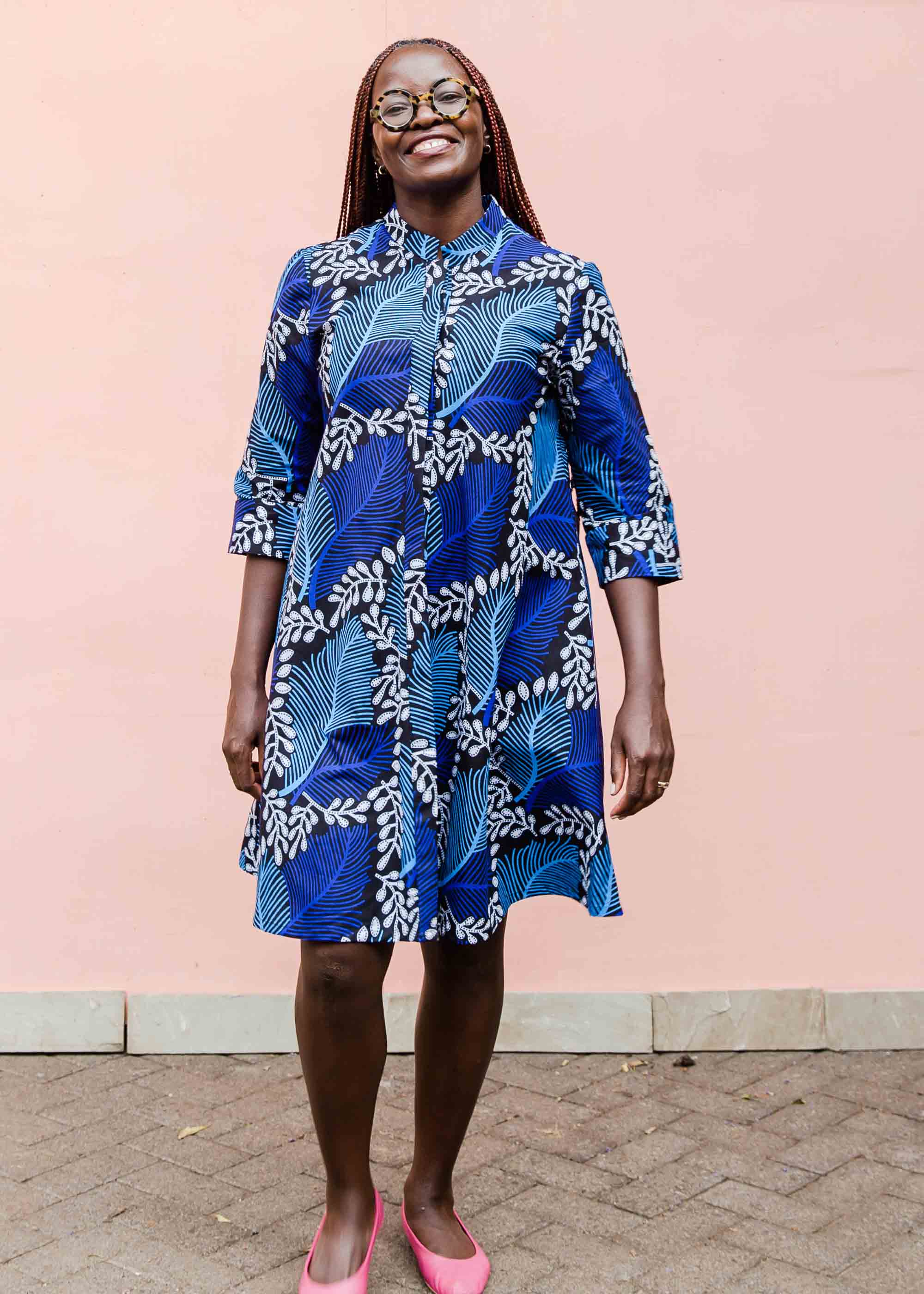 Model wearing blue floral print dress