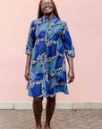 Model wearing blue floral print dress