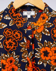 The display of navy dress with orange, brown, black and white floral print