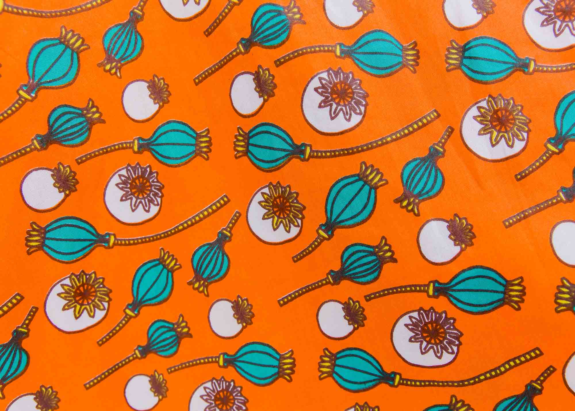 display of an orange, white and green plant design dress