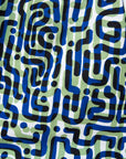 Close up of green, blue, black squiggle print, long sleeved blouse, fabric.