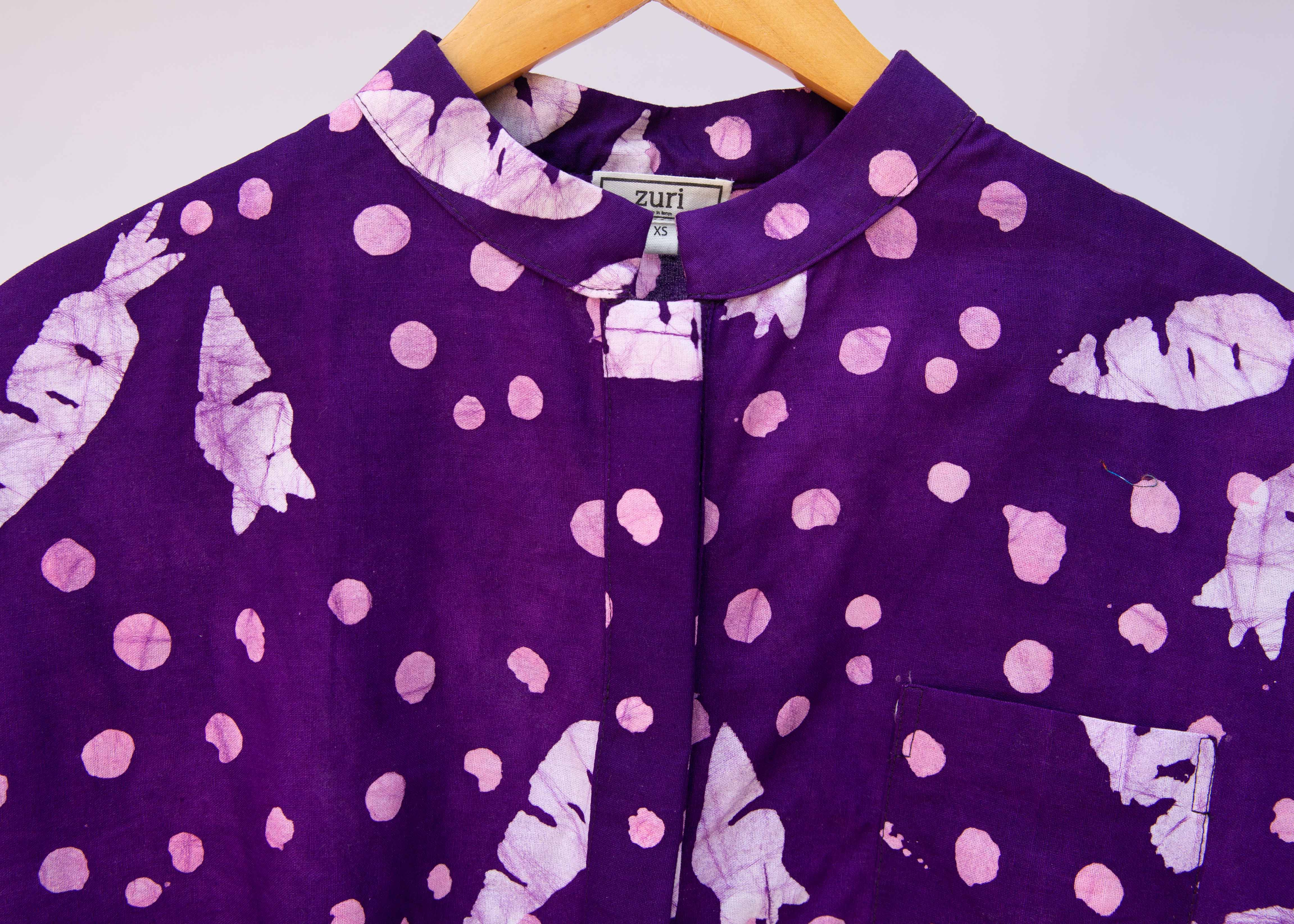Close up of purple shirt with white carrots.
