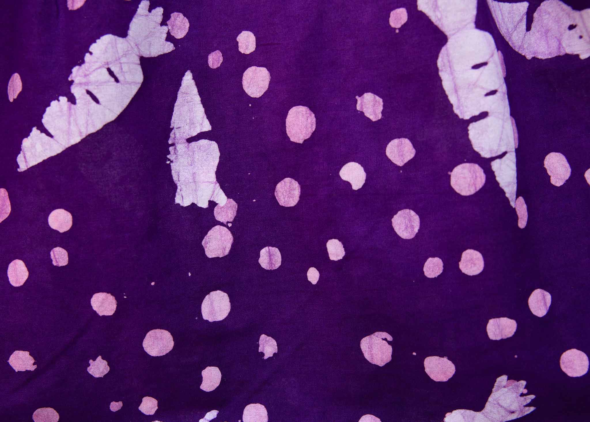 Close up of purple shirt with white carrots.